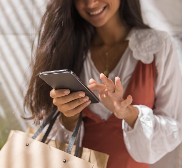 low-angle-beautiful-woman-with-smartphone