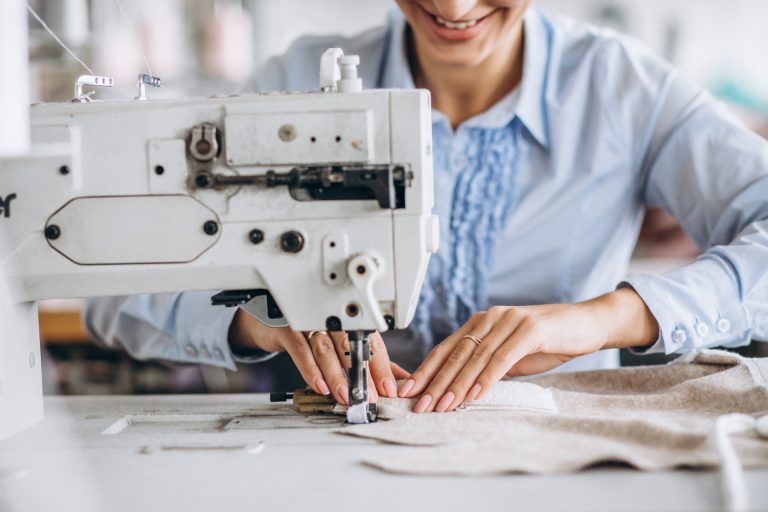 Woman tailor working at the sewing factory Woman tailor working at the sewing factory